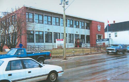 View of the main façade of the Government of Canada Building, showing the continuous strips of glazing and spandrel panels, which contribute to the horizontal expression of the elevations, 1996.; Parks Canada Agency / Agence Parcs Canada, 1996.