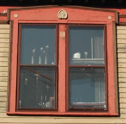 This image provides a view of the second storey double set window with pedimented frame, 2005; City of Saint John