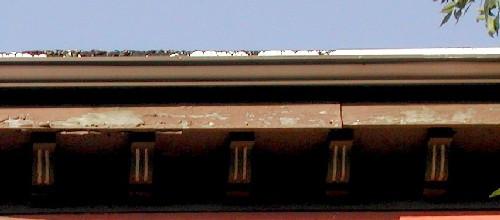 This image shows the large wooden cornice supported by a series of small brackets, 2005; City of Saint John
