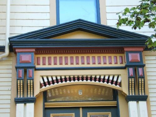 This photograph shows the pediment over the entrance, the ornate brackets and decorative frieze band, 2005; City of Saint John