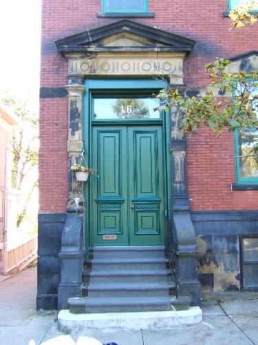 This photograph shows the entrance to the building with pediment, pilasters, and sandstone steps, 2005; City of Saint John
