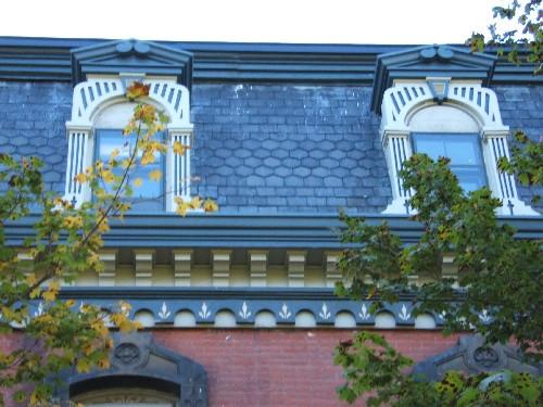 This photograph shows the unique pedimented dormers with Roman arch openings. It also illustrates the brackets and frieze band below the cornice, 2005; City of Saint John