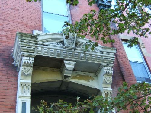 This photograph shows the ornate segmental arch entablature with ornate brackets and keystones, 2005; City of Saint John
