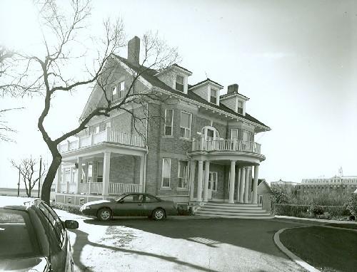 Corner view of the former Bishop's Residence, part of the Gravelbourg Ecclesiastiacal Buildings National Historic Site of Canada, showing its Classical Revival architecture and stylistic sophistication.; Parks Canada Agency / Agence Parcs Canada