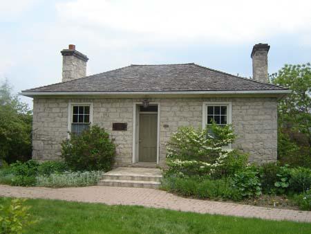 Featured is the hip roof with two double and jointed stone chimneys.; Kayla Jonas, 2007.