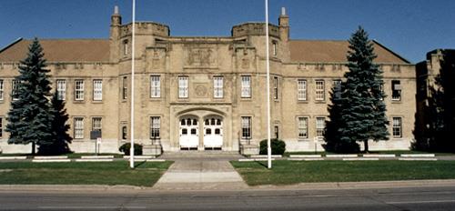 Façade of the Cornwall Armoury, showing the large, symmetrical massing of the principal two-storey façade, 1994.; Department of Public Works / Ministère des Travaux publics, 1994.