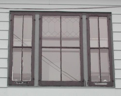This image shows a triple vertical sliding wood window with leaded glass, 2005; City of Saint John
