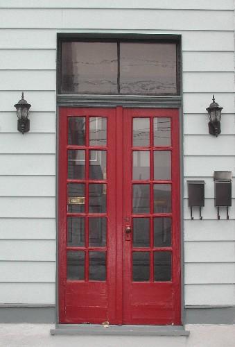 This image shows the two paned transom window over the Craftsmen style paired wood doors with multiple glass panels, 2005; City of Saint John