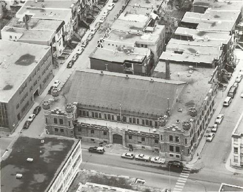 View of the Armoury, showing its dense neighbourhood setting, 1992.; Department of National Defence / Ministère de la Défense nationale, 1992.