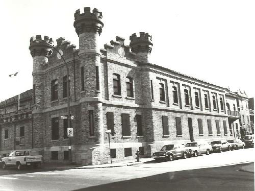 View of the Armoury, showing its medieval architectural details, such as the masonry turrets, 1992.; Department of National Defence / Ministère de la Défense nationale, 1992.