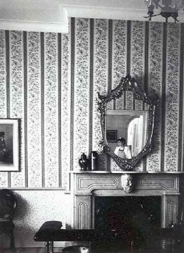 Interior view of Building 1, showing the original fireplace and the woodwork and detailing including classical elements such as the door casings, mouldings and early mantelpieces, 1991.; Parks Canada Agency / Agence Parcs Canada, Ian Doull, 1991.