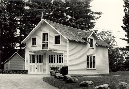 Corner view of the Garage with Servant's Quarters at Moorside, showing the wood double garage doors, small paned casement windows, and the side dormer window, 1985.; Parks Canada Agency / Agence Parcs Canada, M. Trépanier, 1985.