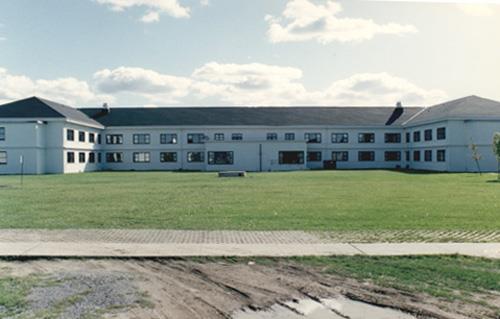 View of the exterior of Building B-37, showing the building’s symmetrical and horizontally emphasized massing, 1993.; Parks Canada Agency / Agence Parcs Canada, 1993.