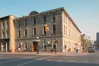 Corner view of the Former Geological Survey of Canada Building showing the continuation of limestone masonry for all cladding and trim, 1991.; Parks Canada Agency / Agence Parcs Canada, 1991.