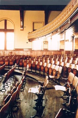 Interior view of Monument-Lefebvre National Historic Site of Canada, showing the theatre with its original seating and historic floor plan.; Parks Canada Agency / Agence Parcs Canada.