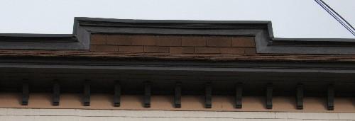 This image provides a view of the parapet crowning the gently sloping roof and the large cornice supported by brackets, 2005; City of Saint John