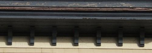 This image provides a view of the large cornice supported by a series of brackets, 2005; City of Saint John