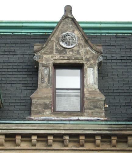 This image provides a view of the pedimented dormer ornamented with a lion's face medallion, 2005; City of Saint John