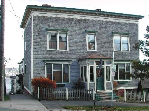 This photograph shows the contextual view of the building facing on Pitt Street with Orange Street and Courtney Bay in the background, 2005; City of Saint John