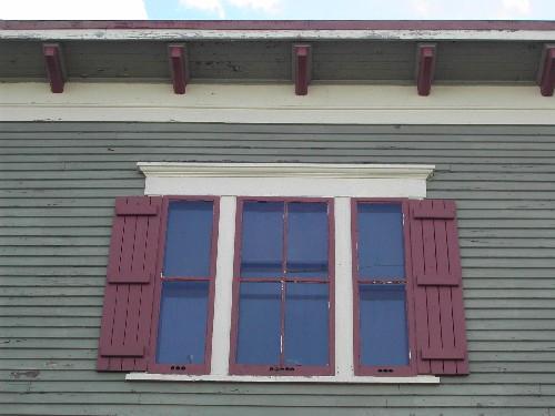 This photograph shows one of three triple set windows and the roof-line cornice ornamented with modillions, 2005; City of Saint John