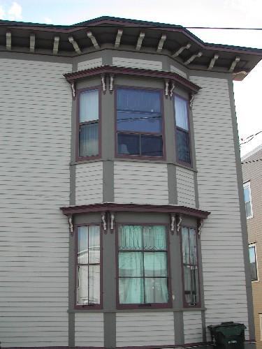 This photograph shows the bay window and the large roof-line cornice decorated with modillions, 2005; City of Saint John