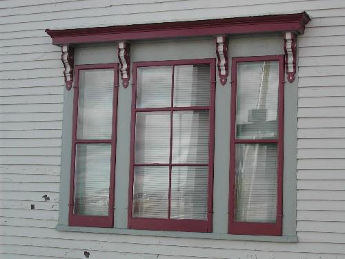 This photograph shows one of the two triple windows with bracketed entablature, 2005; City of Saint John