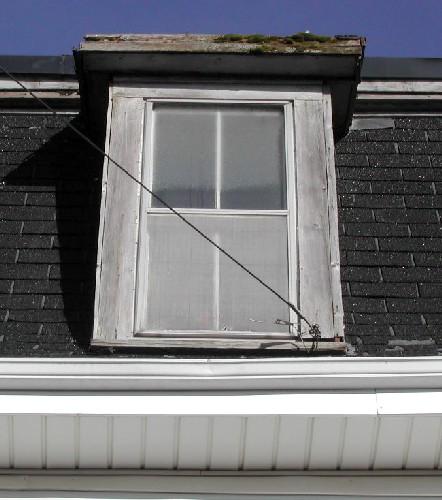 This image provides a view of a dormer above the projected cornice, 2005
; City of Saint John