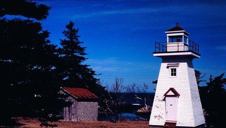 Front elevation and grounds surrounding Hampton Lighthouse on Chute Bay, NS, 2002.; Hampton Lighthouse and Historical Society March 2002