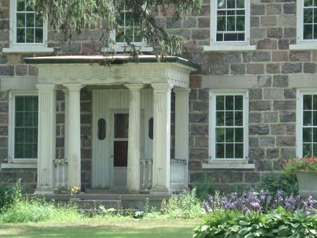 Featured is the central portico with fluted Doric columns and decorative frieze.; Martina Braunstein, 2007.