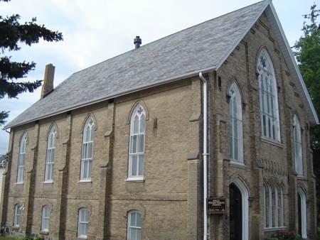 Of note are the double trefoil lancet windows between each brick buttress.; Kayla Jonas, 2007.