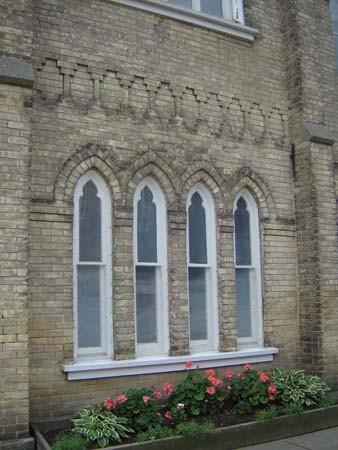 Featured are the four narrow double-hung windows, including common sill and gothic surround.; Kayla Jonas, 2007.
