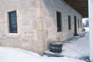 Detail view of the St. Andrew's Rectory, showing the original, surviving, limestone blocks quarried from the nearby riverbank, 1991.; Parks Canada Agency / Agence Parcs Canada, D. McArthur, 1991.