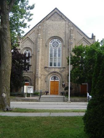 Of note is the broad gable with central recessed doorway.; Kayla Jonas, 2007.