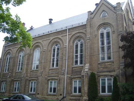 Of note are the round-headed windows and the triangular window in the gable.; Kayla Jonas, 2007.