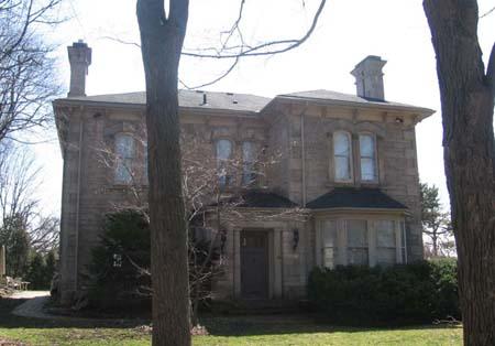 Featured are paired, arched upper windows and one-storey entry porch supported by circular columns.; Lindsay Benjamin, 2007.