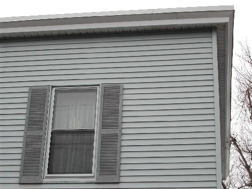 This photograph shows one of the upper storey windows and the eaves, 2005; City of Saint John