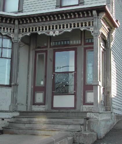 This image provides a view of the highly ornate verandah, the transom window and sidelights surrounding the entry, 2006; City of Saint John