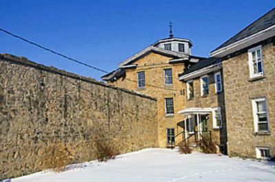 Exterior view of the Huron County Gaol, showing the two-storey-high walls, 1995.; Parks Canada Agency / Agence Parcs Canada, J. Butterill, 1995.