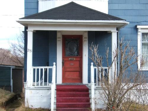 This photograph shows the wooden door and the portico supported by pillars, 2006; City of Saint John