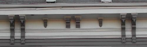 This image provides a view of the wood cornice supported by a series of paired and single brackets, 2006; City of Saint John
