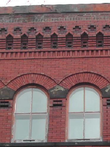 This photograph shows the cornice and the upper storey roman arch windows, 2005; City of Saint John