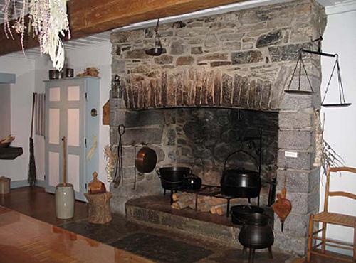 Interior view of Maison Saint-Gabriel, showing one of the large, stone fireplaces, 2005.; Parks Canada Agency / Agence Parcs Canada, N. Clerk, 2005.