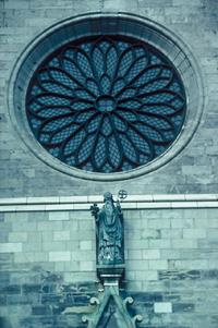Detail view of St. Patrick's Basilica, showing its French Gothic Revival rose window, 1995.; Parks Canada Agency / Agence Parcs Canada, P. St. Jacques, 1995.