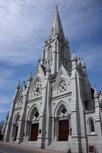 General view of St. Mary's Basilica, showing the High Victorian Gothic Revival style facade with its elaborate triple portal and central tower with dressed granite spire, 2009.; St. Mary's Basilica, Glenn Euloth, 2009.