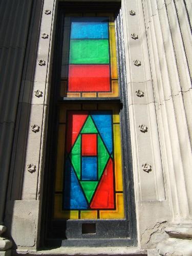 This photograph shows one of the high rectangular windows with floral motifs in the surrounds, 2005; City of Saint John