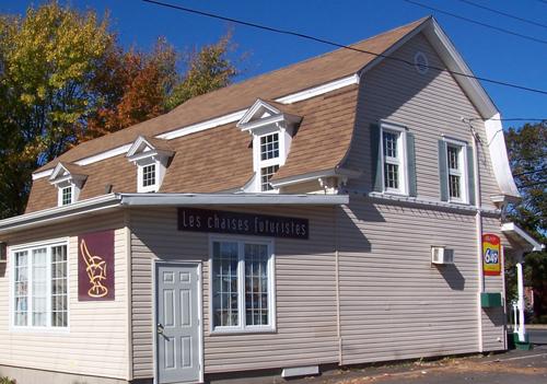 This image shows a lateral view of the building, highlighting the traditional gambrel roof, 2007; Town of Shippagan