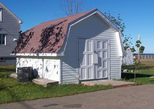 This image shows the shed in the same style as the house; Town of Shippagan