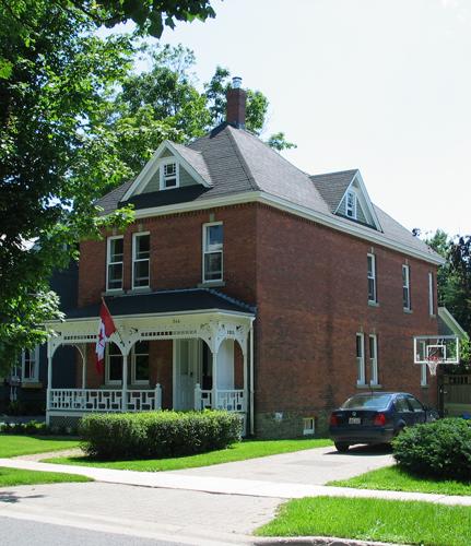 This image shows the front façade and the western side of residence; City of Fredericton