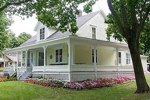 Front and side elevations with gable roof, dormer and wrap-around verandah.; PNB 2003