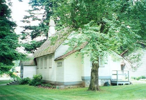 Rear view of Christ Church, showing the original exterior wall surfaces, 1994.; Agence Parcs Canada/ Parks Canada Agency, Janet Wright, 1994.